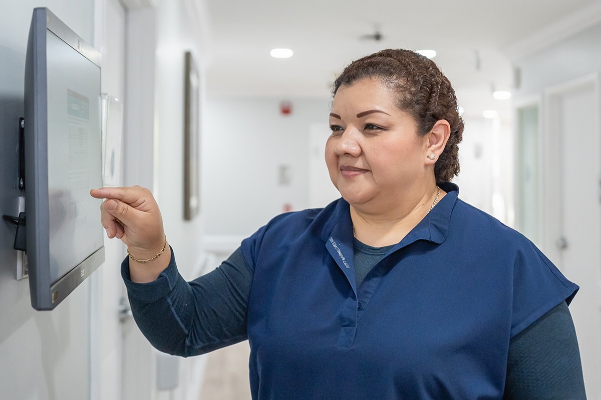 Staff member touching computer