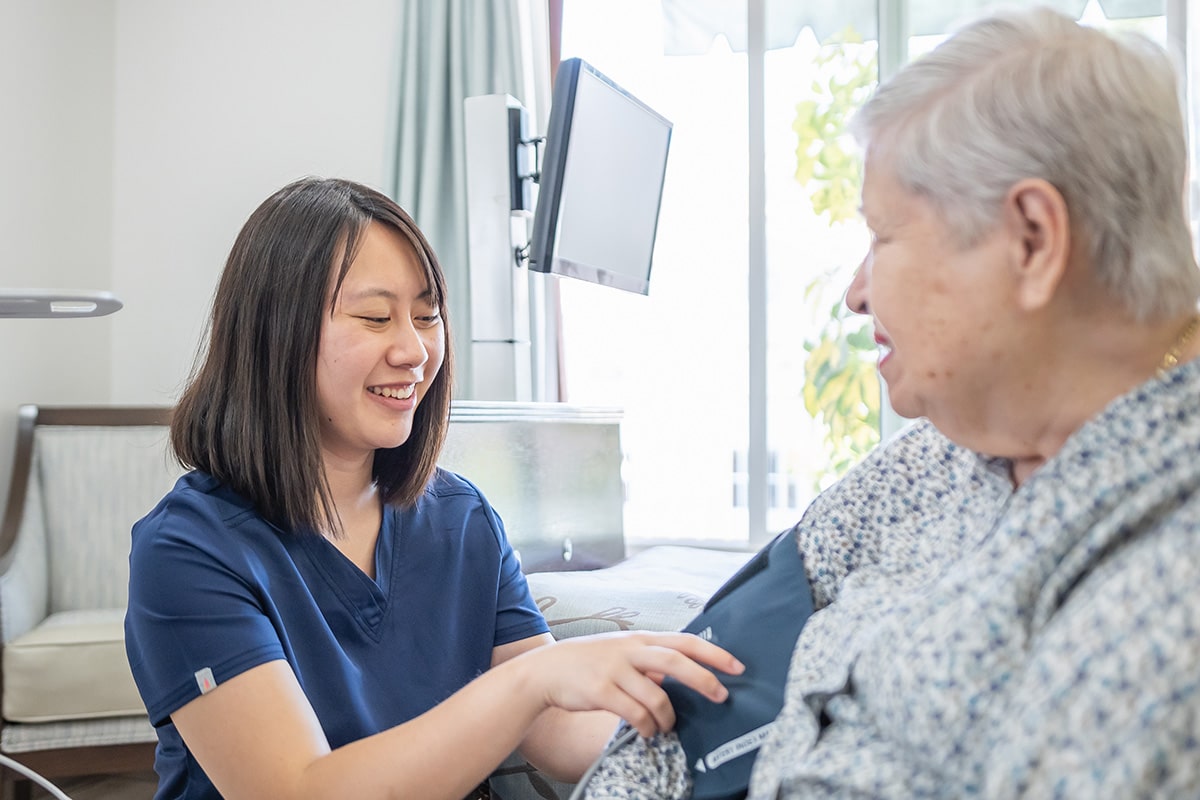 Healthcare worker taking blood pressure of woman