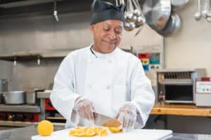 Chef chopping orange