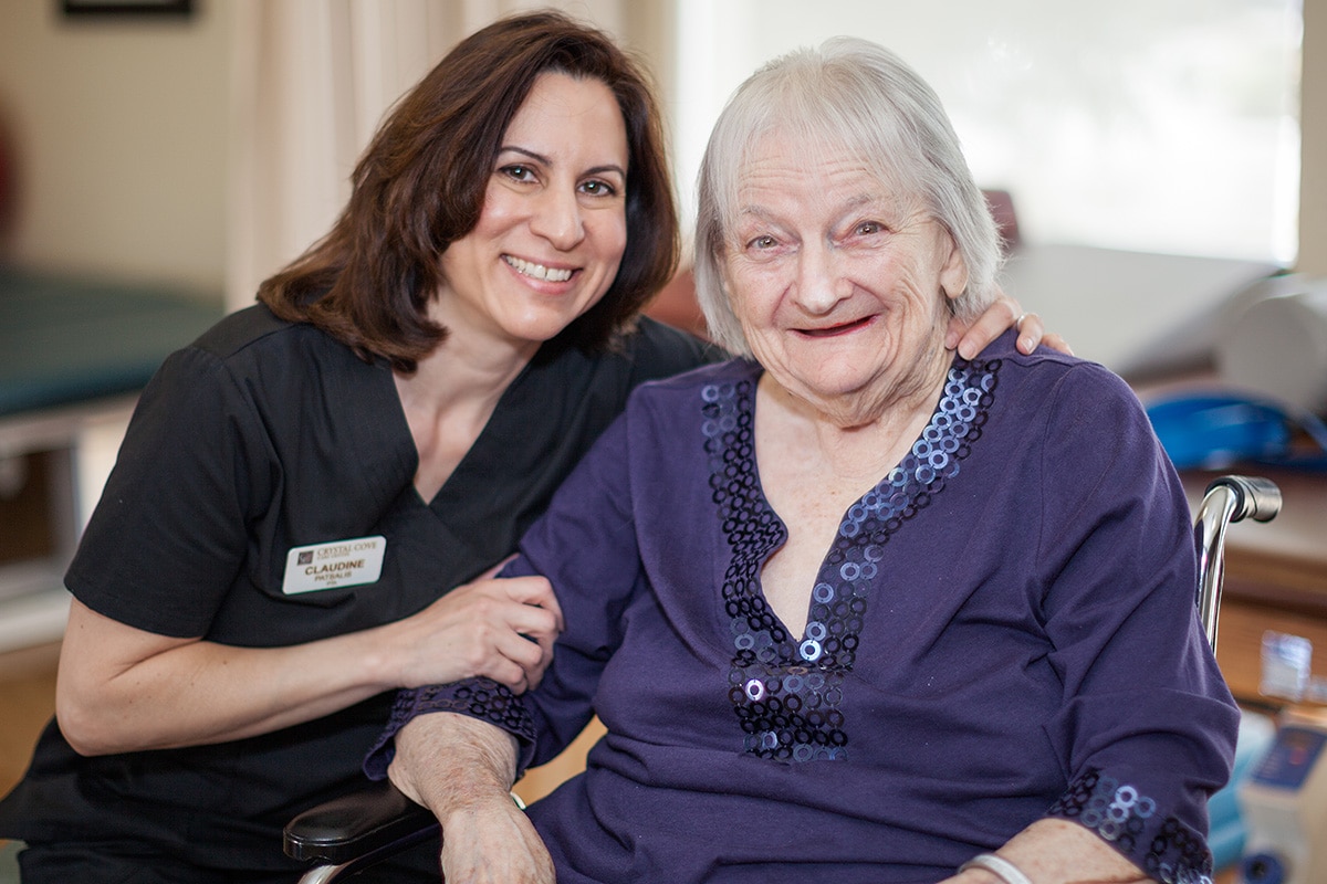 Healthcare worker with resident in purple shirt
